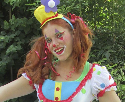 A cheerful clown with a flower hat