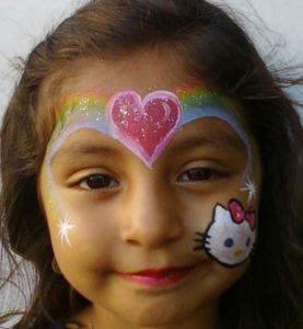 The Front of the Face of a Girl With a Rainbow Paint