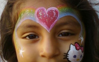The Front of the Face of a Girl With a Rainbow Paint