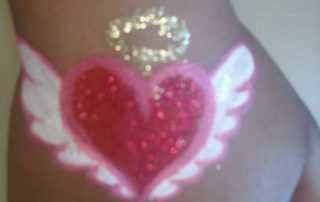 A Heart Shape Painting With Glitter With Wings