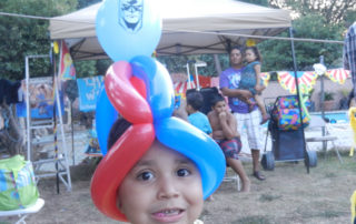 The Front of a Boys Face With a Red and Blue Balloon
