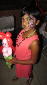 A Little Girl Holding a Balloon Figure in Hand