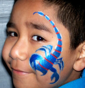 A Little Boy With a Scorpion Painting on the Face