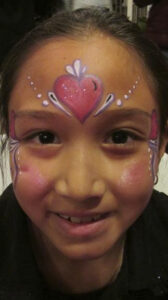 A Little Girl With a Pink Color Heart Painting