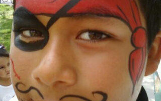A Little Boy With a Pirate Style Face Painting