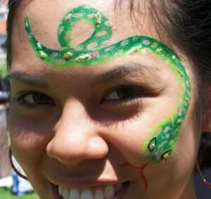 A Person With Snake Painting on Face
