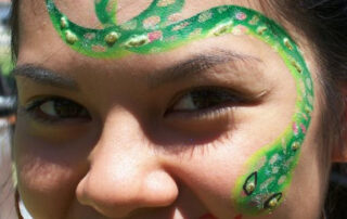 A Person With Snake Painting on Face