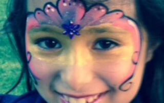 A Little Girl With Pink and Blue Face Painting