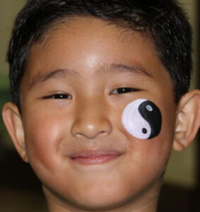 A Little Boy With a Ying Yang Painting