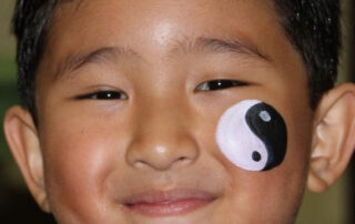 A Little Boy With a Ying Yang Painting