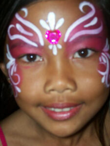 A Little Girl With White Pattern Painting on Face