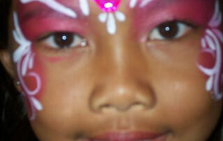 A Little Girl With White Pattern Painting on Face