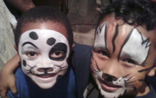 Two Little Boys With Tiger Themed Face Painting