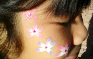 The Side of a Girls Face With Small Flowers