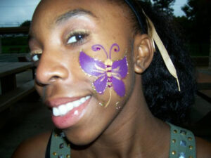A Little Girl With a Butterfly Shape Painting on Cheek