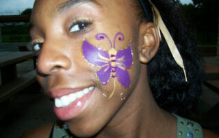 A Little Girl With a Butterfly Shape Painting on Cheek