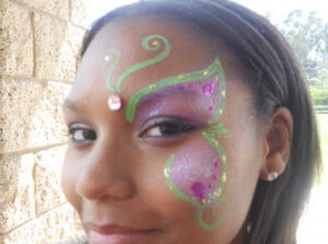 The Side of a Girls Face With a Half Butterfly Painting