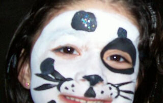 A Face With a Cat Type Face Painting in White and Black