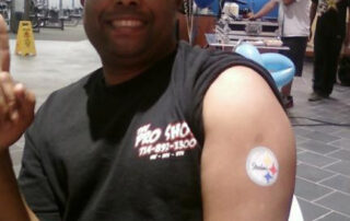 A Mans Arm With a Patch in White Color With Logo