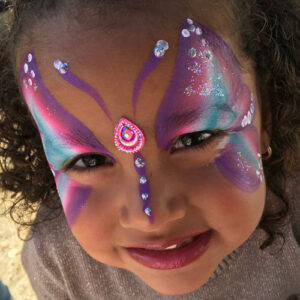 A Little Girl With a Painting of a Butterfly on Face