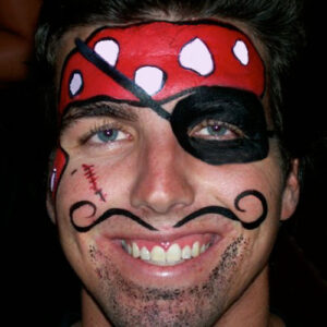 A Boy With a Pirate Themed Face Painting and Beard