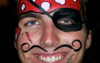 A Boy With a Pirate Themed Face Painting and Beard