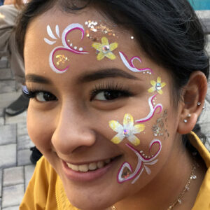 A Girl With Yellow and White Face Painting