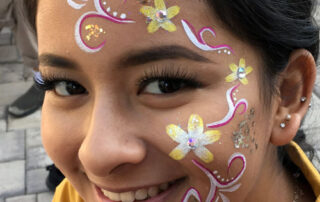A Girl With Yellow and White Face Painting