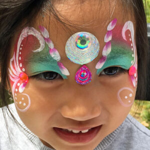 The Front of a Little Girl With a Butterfly Paint