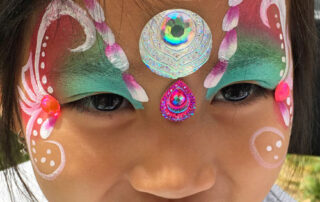The Front of a Little Girl With a Butterfly Paint