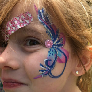 The Side of the Face of a Girl With a Butterfly Paint