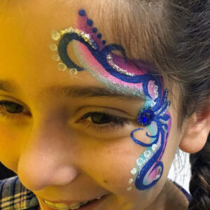 A Girls Face With a Butterfly With Stones Studding