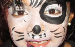 A Little Boy With a White Tiger Face Painting