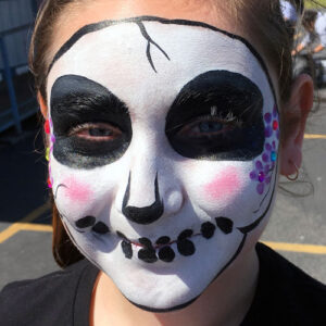 A Little Girl With a Skeleton Figure in White