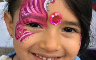 The Front of a Girls Face With a Pink Color Wing