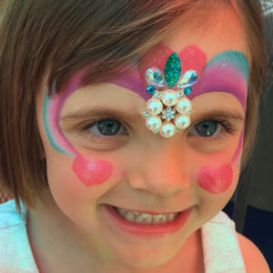 A Girls Face With Pearls and Gems Studded Paint