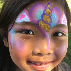The Face of a Woman With a Unicorn Face Paint