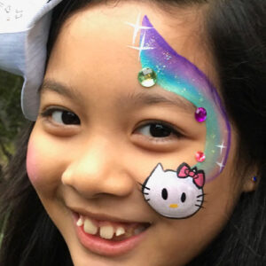 A Hello Kitty Painting on the Face of a Girl