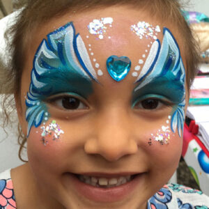 A Little Girl With Face Painting in Blue