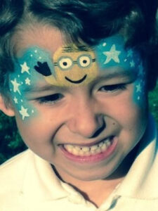 A Little boy With a Minions Themed Face Painting