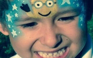 A Little boy With a Minions Themed Face Painting
